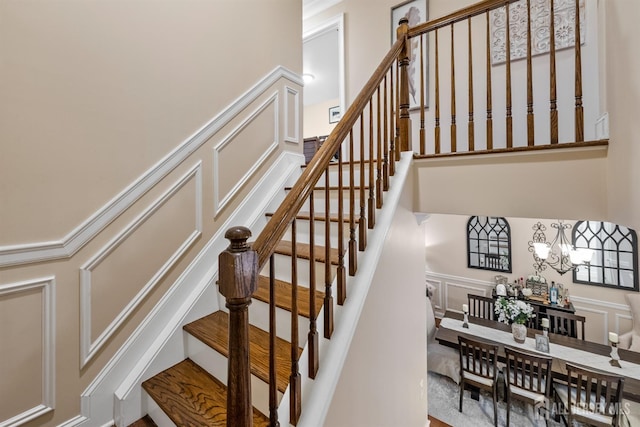 20 Mccormick Ave, Old Bridge, NJ 08857 - stairs with a decorative wall, a wainscoted wall, a high ceiling, and a chandelier