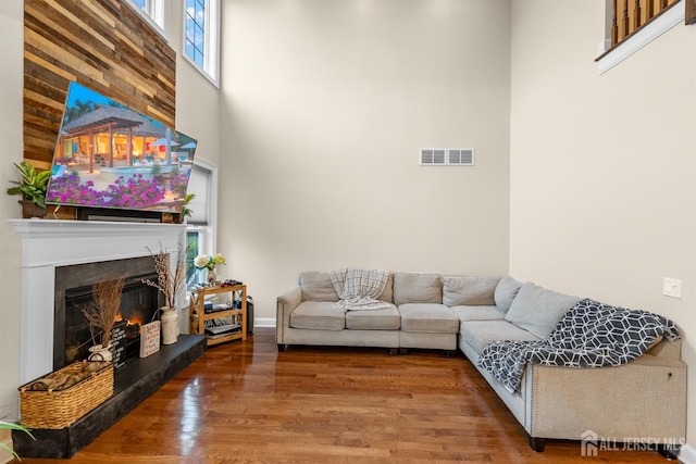 20 Mccormick Ave, Old Bridge, NJ 08857 - living room featuring a warm lit fireplace, wood finished floors, and a high ceiling