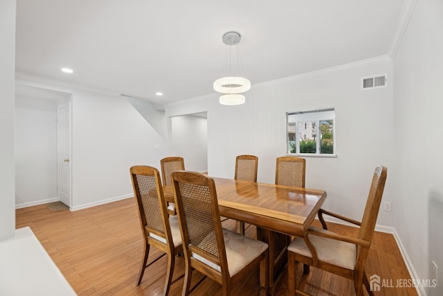 210 N 2nd Ave, Highland Park, NJ 08904 - dining area with crown molding, light wood-style flooring, recessed lighting, and baseboards