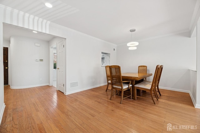 210 N 2nd Ave, Highland Park, NJ 08904 - dining area with light wood finished floors, ornamental molding, and baseboards