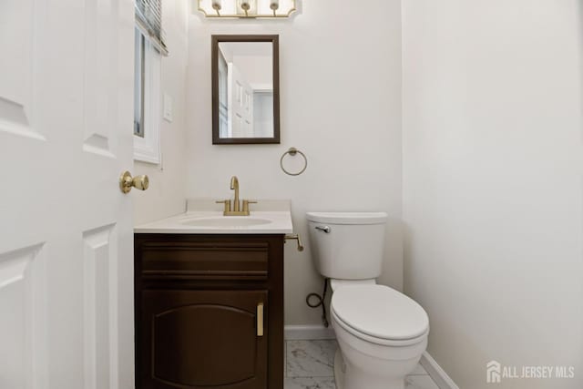 210 N 2nd Ave, Highland Park, NJ 08904 - half bathroom with vanity, toilet, marble look tiles, and baseboards