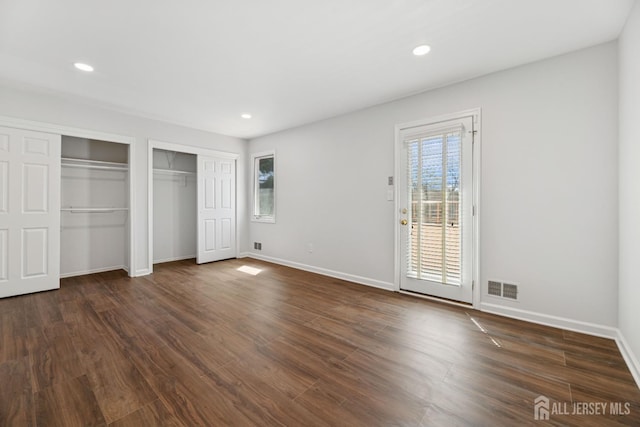 210 N 2nd Ave, Highland Park, NJ 08904 - unfurnished bedroom featuring multiple closets, access to exterior, baseboards, dark wood finished floors, and recessed lighting