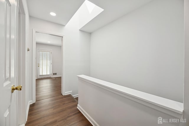 210 N 2nd Ave, Highland Park, NJ 08904 - hall with an upstairs landing, dark wood-type flooring, a skylight, baseboards, and recessed lighting