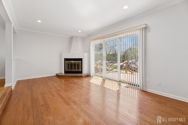 210 N 2nd Ave, Highland Park, NJ 08904 - unfurnished living room with ornamental molding, baseboards, wood finished floors, a fireplace, and recessed lighting