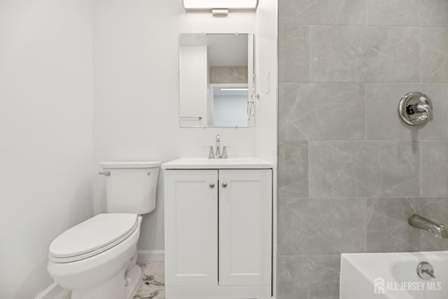 210 N 2nd Ave, Highland Park, NJ 08904 - bathroom featuring vanity, toilet, marble look tile flooring, baseboards, and tub / shower combination
