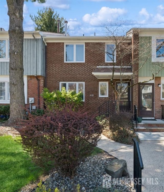 210 N 2nd Ave, Highland Park, NJ 08904 - townhome / multi-family property featuring brick siding and board and batten siding