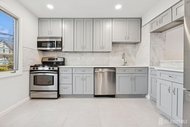 210 N 2nd Ave, Highland Park, NJ 08904 - kitchen featuring appliances with stainless steel finishes, gray cabinetry, plenty of natural light, and recessed lighting