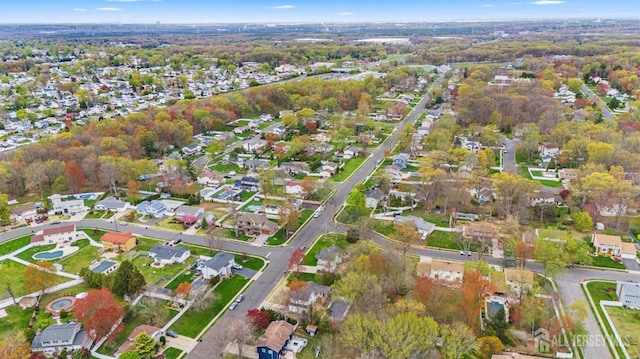 aerial view of property and surrounding area with nearby suburban area