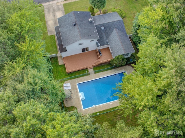view of subject property with a pool