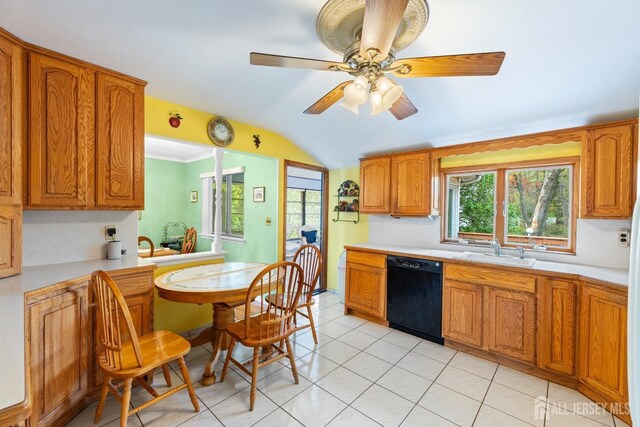 kitchen featuring black dishwasher, a sink, light countertops, brown cabinetry, and lofted ceiling