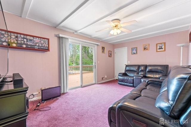 carpeted living area with a ceiling fan, beamed ceiling, and baseboards