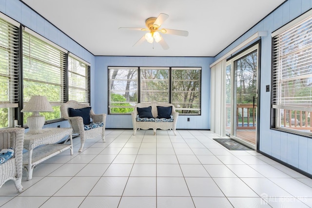 sunroom featuring a ceiling fan