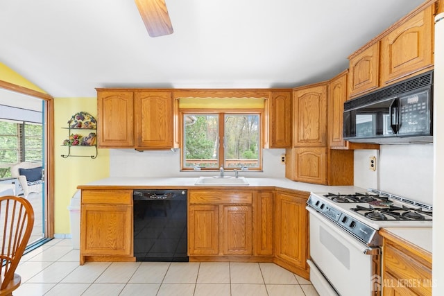 kitchen with black appliances, a sink, light countertops, and healthy amount of natural light