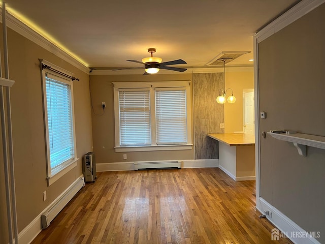 interior space featuring hardwood / wood-style floors, ceiling fan with notable chandelier, crown molding, and a baseboard heating unit