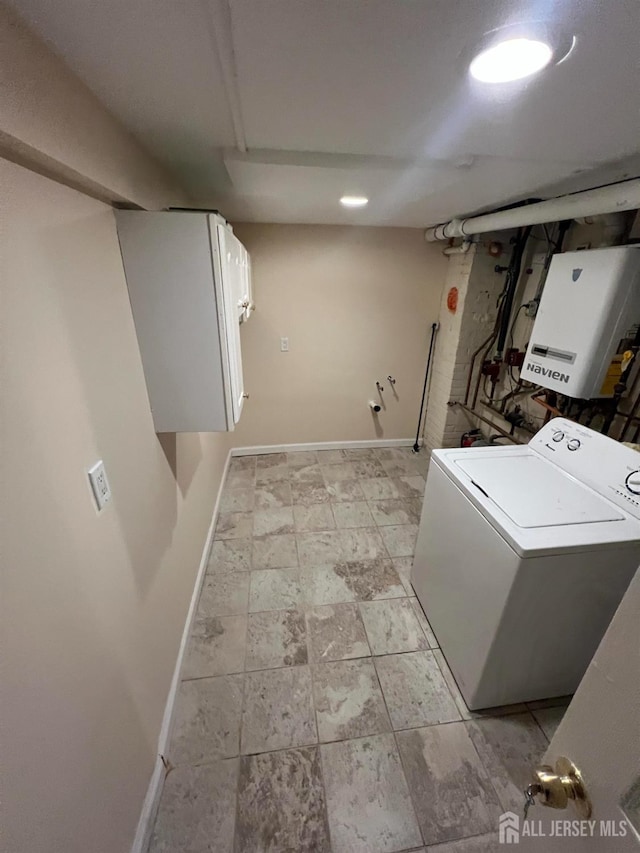 laundry area featuring cabinets, washer / dryer, and tankless water heater