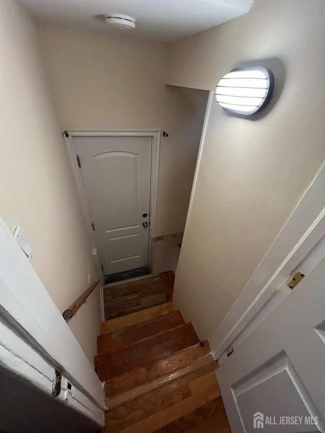 stairway featuring hardwood / wood-style floors