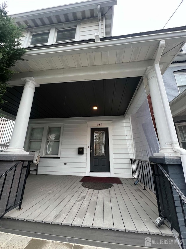 view of exterior entry featuring a porch