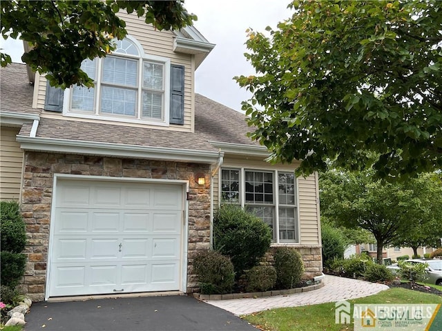 1 Silcox Pl, Franklin, NJ 08873 - view of front of property featuring stone siding, a shingled roof, an attached garage, and driveway