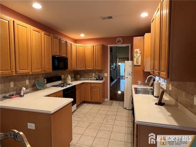1 Silcox Pl, Franklin, NJ 08873 - kitchen with black microwave, gas range, decorative backsplash, light countertops, and freestanding refrigerator