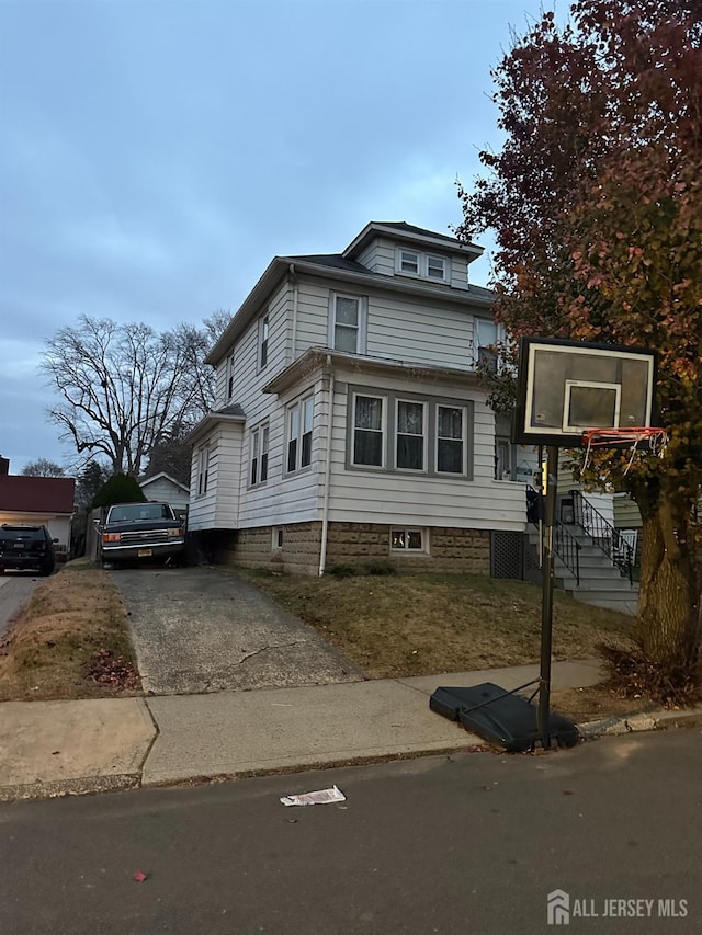 13 Garwood St, South River, NJ 08882 - view of home's exterior featuring a lawn and driveway
