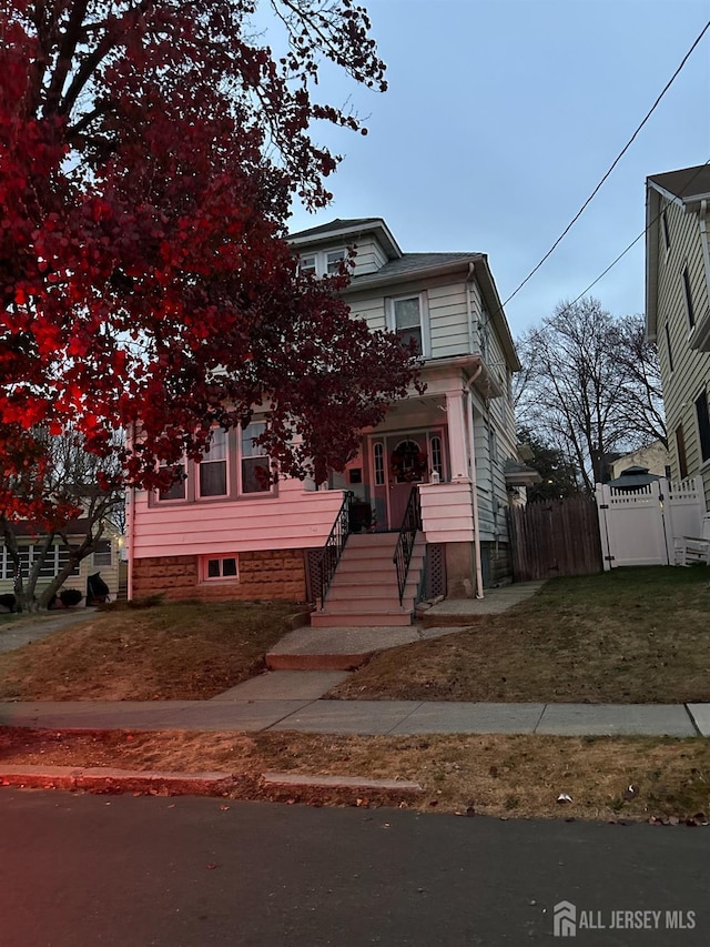 view of front of house featuring fence