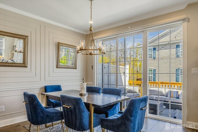 58 Begonia Ln, Monroe, NJ 08831 - dining space featuring a chandelier, ornamental molding, wood finished floors, and baseboards
