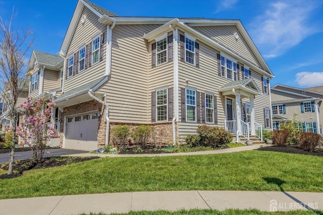 58 Begonia Ln, Monroe, NJ 08831 - view of front of house featuring a front yard, a garage, asphalt driveway, and stone siding