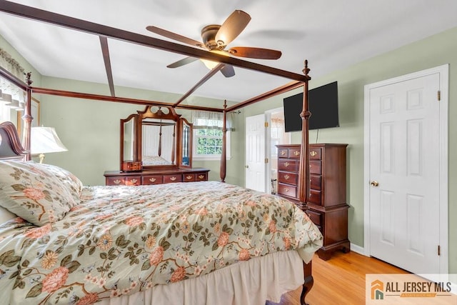 bedroom with light wood-style floors and a ceiling fan