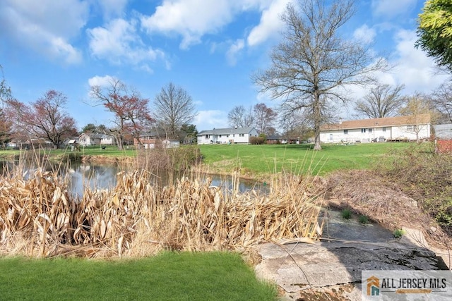 view of yard featuring a water view and a residential view