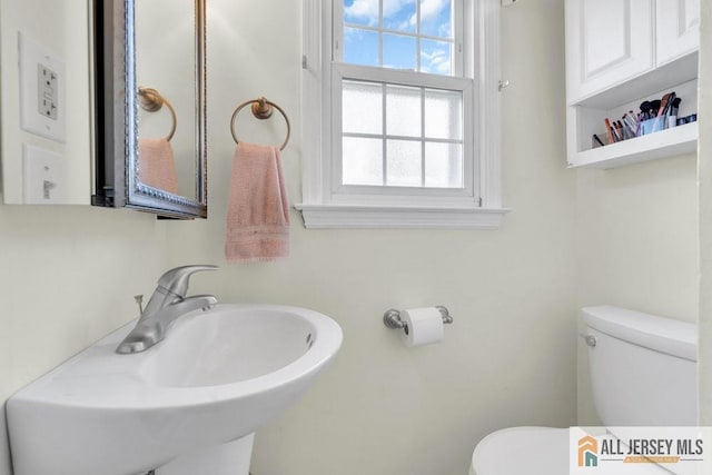 bathroom featuring toilet and a sink