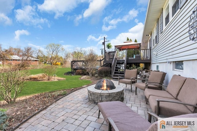 view of patio / terrace with stairway, a gazebo, a wooden deck, and an outdoor fire pit