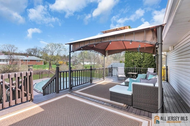 wooden terrace featuring a gazebo and an outdoor living space
