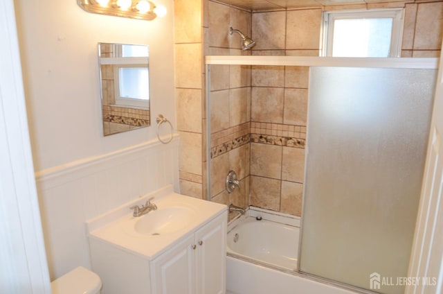 179 Decker Pl, Woodbridge Proper, NJ 07095 - bathroom with vanity, shower / bath combination with glass door, and a wainscoted wall