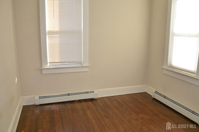 179 Decker Pl, Woodbridge Proper, NJ 07095 - spare room featuring a baseboard radiator and dark wood-style flooring