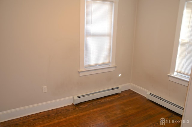 179 Decker Pl, Woodbridge Proper, NJ 07095 - empty room featuring a baseboard radiator and dark wood-style floors