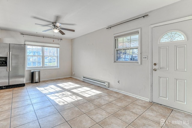 foyer with light tile patterned floors, a healthy amount of sunlight, and a baseboard radiator