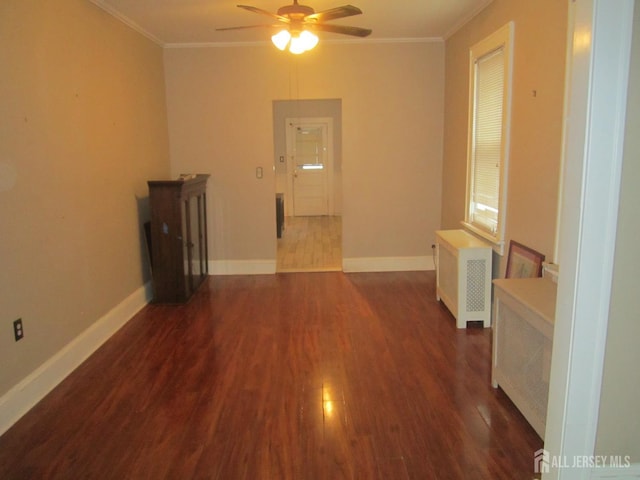 458 S Barclay St, Perth Amboy, NJ 08861 - spare room with crown molding, dark wood-style floors, ceiling fan, and radiator