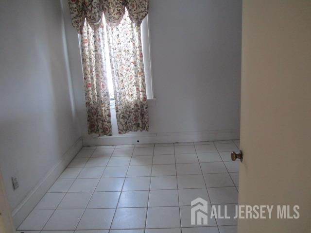 458 S Barclay St, Perth Amboy, NJ 08861 - unfurnished room with tile patterned floors