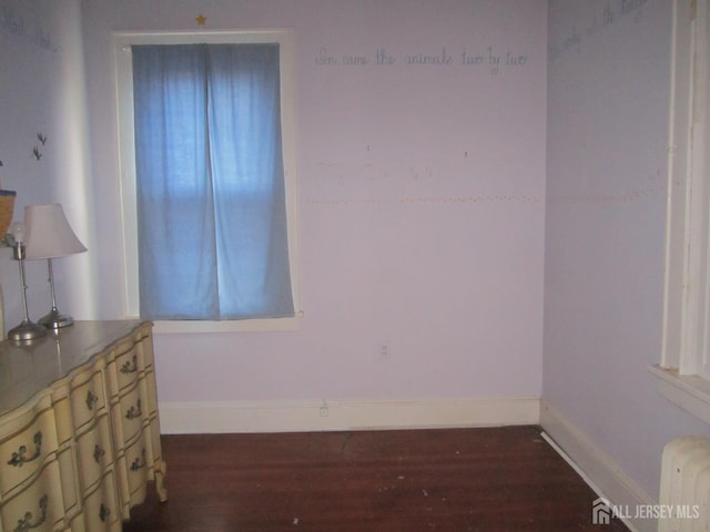458 S Barclay St, Perth Amboy, NJ 08861 - unfurnished room featuring dark wood-style floors and radiator