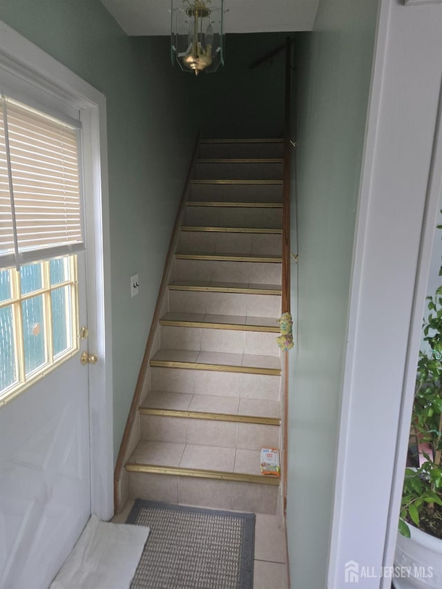 533 W Side Ave W, Perth Amboy, NJ 08861 - stairway featuring tile patterned flooring and a chandelier