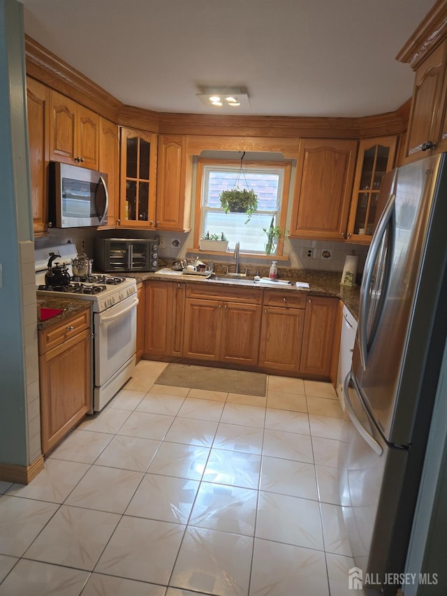 533 W Side Ave W, Perth Amboy, NJ 08861 - kitchen with stainless steel appliances, brown cabinetry, and glass insert cabinets