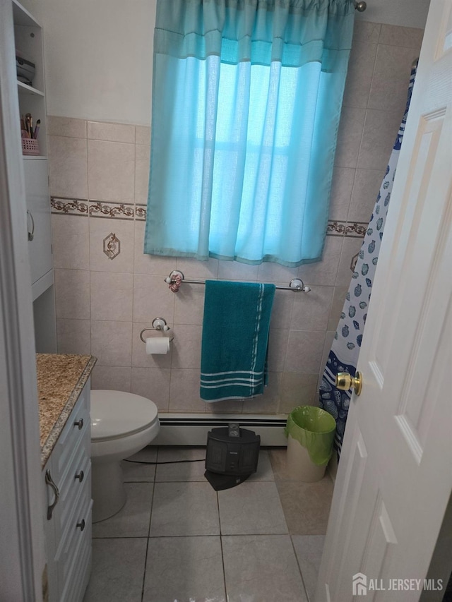 533 W Side Ave W, Perth Amboy, NJ 08861 - bathroom featuring tile walls, a baseboard radiator, tile patterned floors, vanity, and toilet
