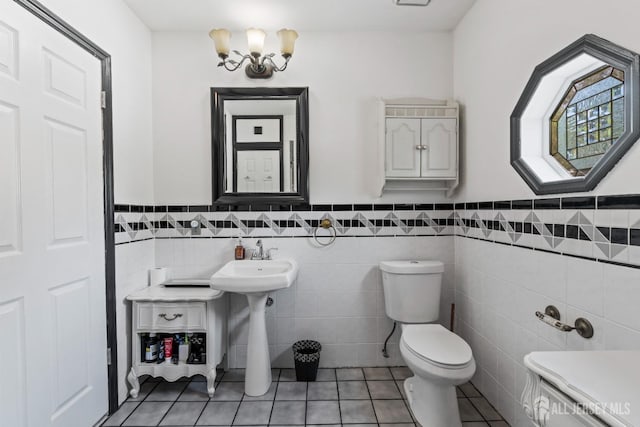 229 Greenbrook Rd, Green Brook, NJ 08812 - half bath with tile patterned floors, tile walls, a wainscoted wall, and a chandelier