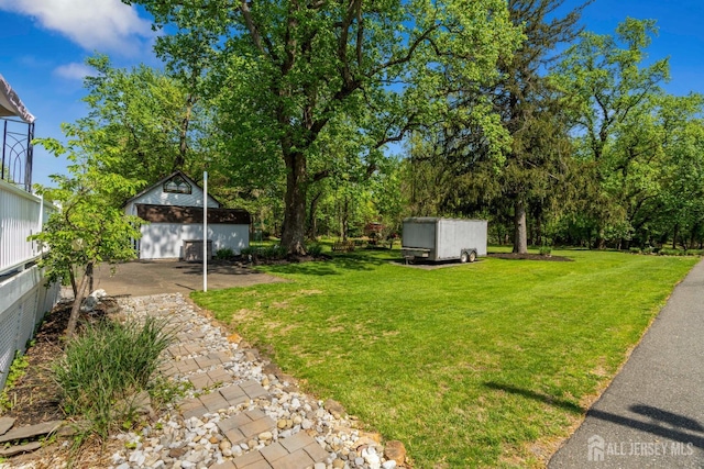 229 Greenbrook Rd, Green Brook, NJ 08812 - view of green lawn with an outbuilding, view of wooded area, and a detached garage