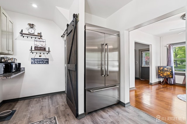 229 Greenbrook Rd, Green Brook, NJ 08812 - kitchen with built in fridge, a barn door, wood finished floors, open shelves, and recessed lighting