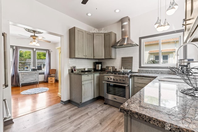 229 Greenbrook Rd, Green Brook, NJ 08812 - kitchen featuring a ceiling fan, wall chimney range hood, high end stainless steel range, light wood-type flooring, and decorative backsplash