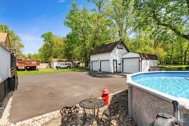 229 Greenbrook Rd, Green Brook, NJ 08812 - swimming pool with an outdoor structure and view of wooded area