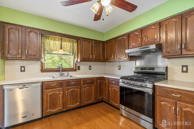 59 Normandy Dr, Piscataway, NJ 08854 - kitchen with appliances with stainless steel finishes, under cabinet range hood, a ceiling fan, light countertops, and light wood-style flooring