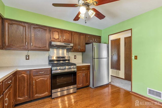 59 Normandy Dr, Piscataway, NJ 08854 - kitchen with stainless steel appliances, under cabinet range hood, light countertops, ceiling fan, and wood finished floors