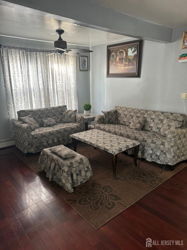 living room featuring ceiling fan and dark wood-type flooring